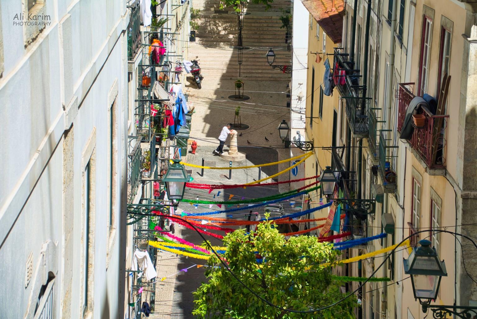 Typical gulleyways between apartment buildings; note the water fountain and the laundry Lisbon Portugal: Typical gulleyways between apartment buildings; note the water fountain and the laundry