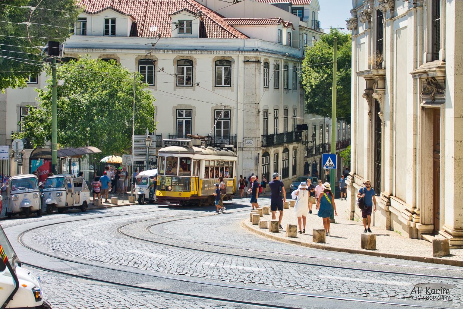 Alfama and Tram 28; outside the Lisbon Cathedral (Sé de Lisboa). Tuk-tuks were also popular with tourists Lisbon Portugal: Alfama and Tram 28; outside the Lisbon Cathedral (Sé de Lisboa). Tuk-tuks were also popular with tourists