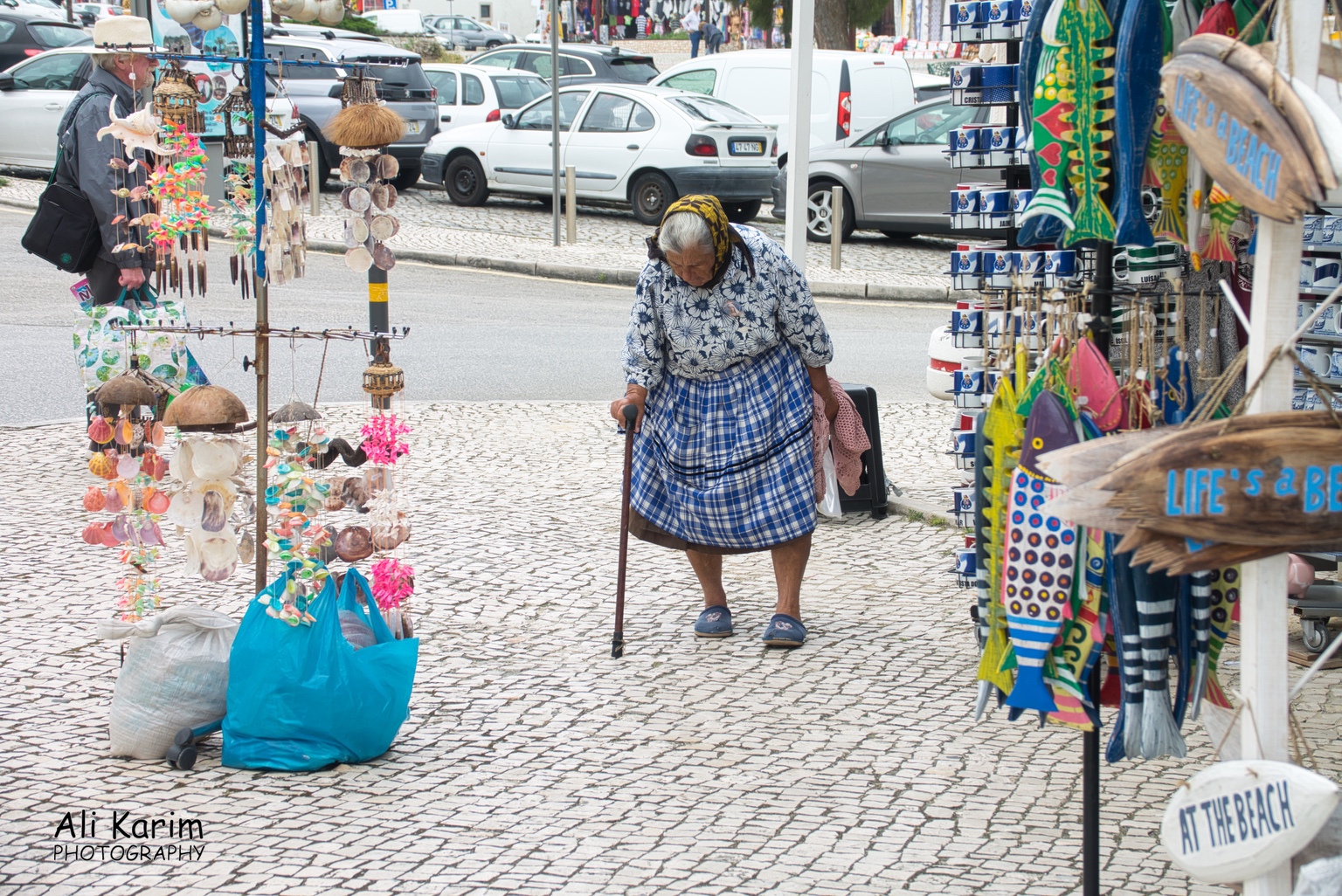 Traditionally dressed lady, walking past the tourist shops West of Lisbon Traditionally dressed lady, walking past the tourist shops