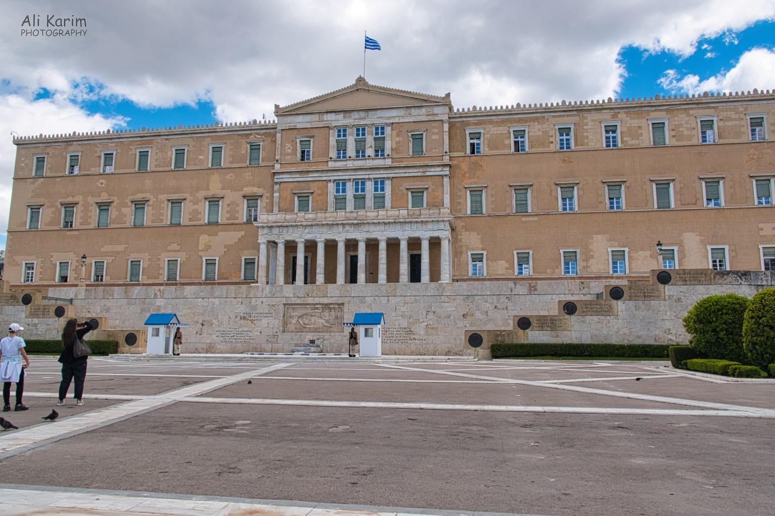 Greek Parliament building housed in the Old Royal Palace facing Syntagma square. The Tomb of the unknown soldier is in the front between the 2 sentry boxes. More Athens, Greece, May 2021, Greek Parliament building housed in the Old Royal Palace facing Syntagma square. The Tomb of the unknown soldier is in the front between the 2 sentry boxes.