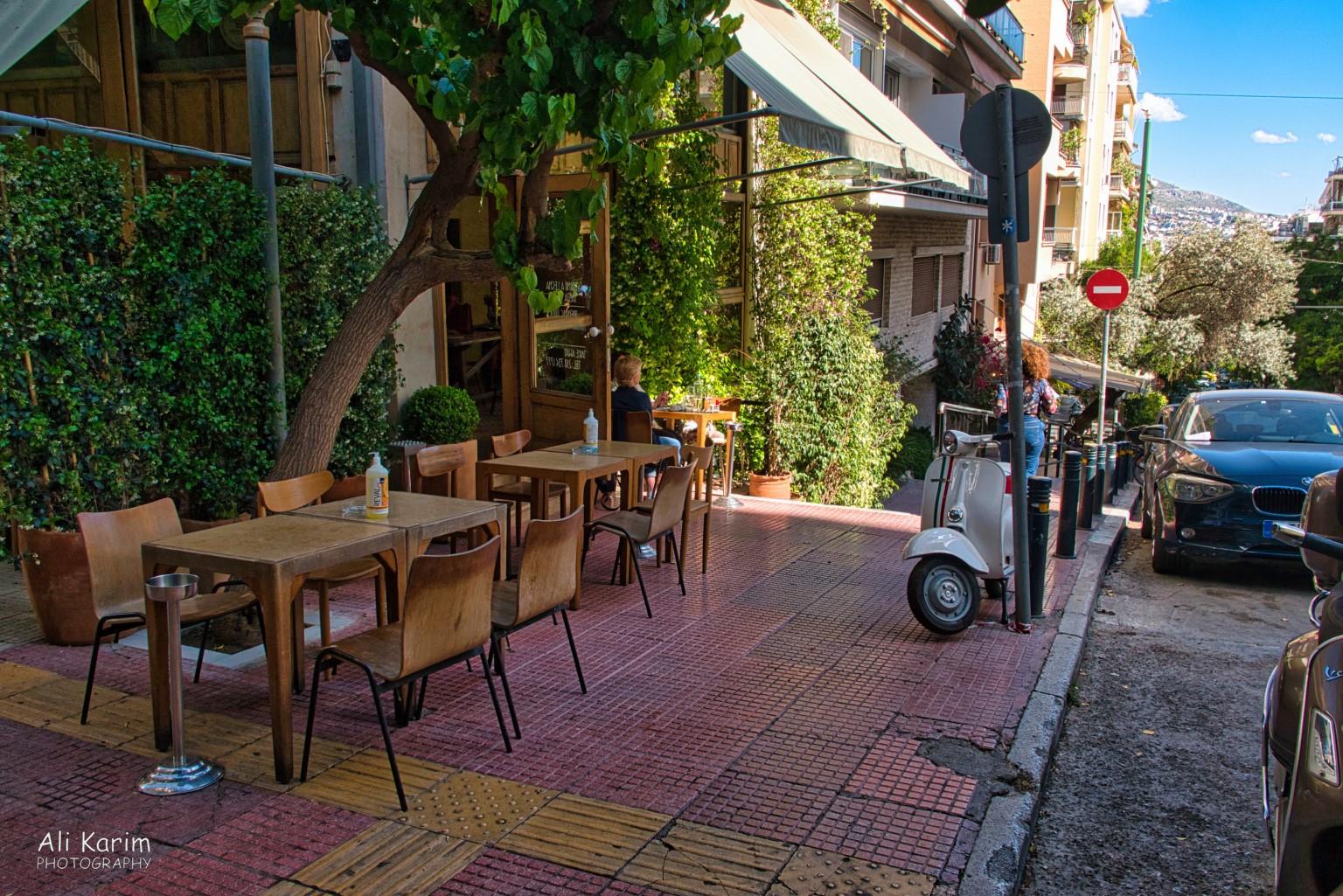 Cute sidewalk cafés along the walk down More Athens, Greece, May 2021, Cute sidewalk cafés along the walk down
