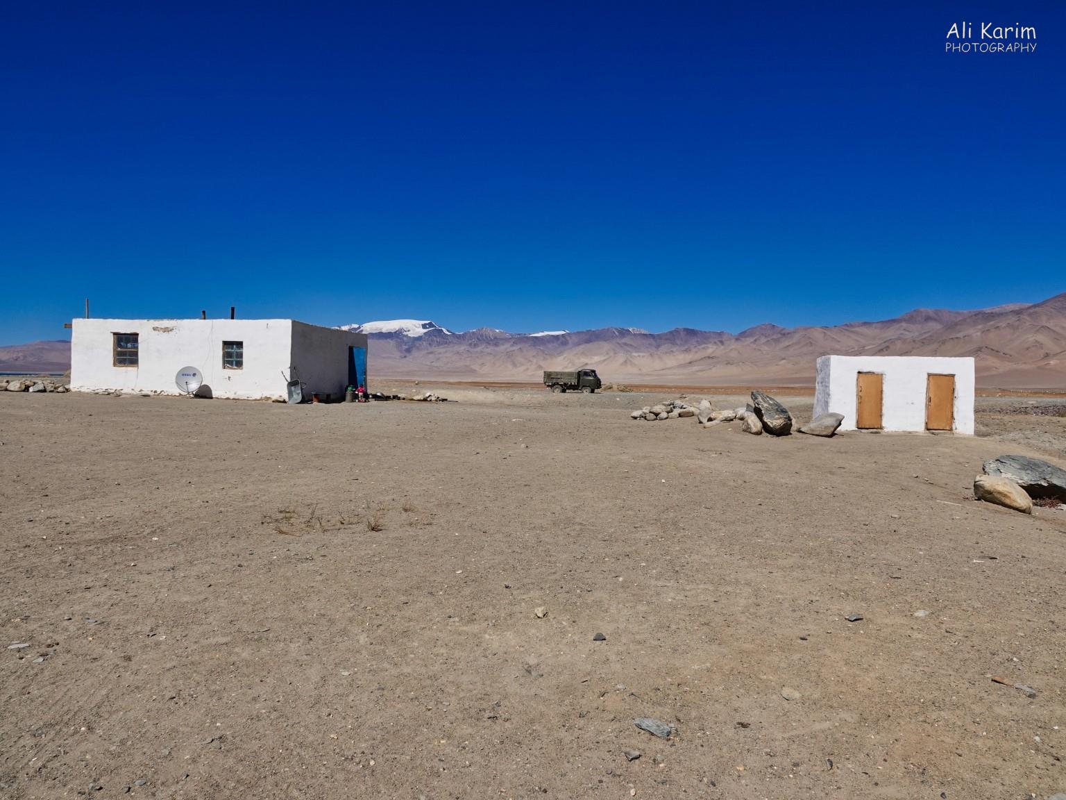 Lunch was at this homestay (left) in Karakul; outhouse bathrooms on the right Silk Road 18: Murghab, Tajikistan Lunch was at this homestay (left) in Karakul; outhouse bathrooms on the right