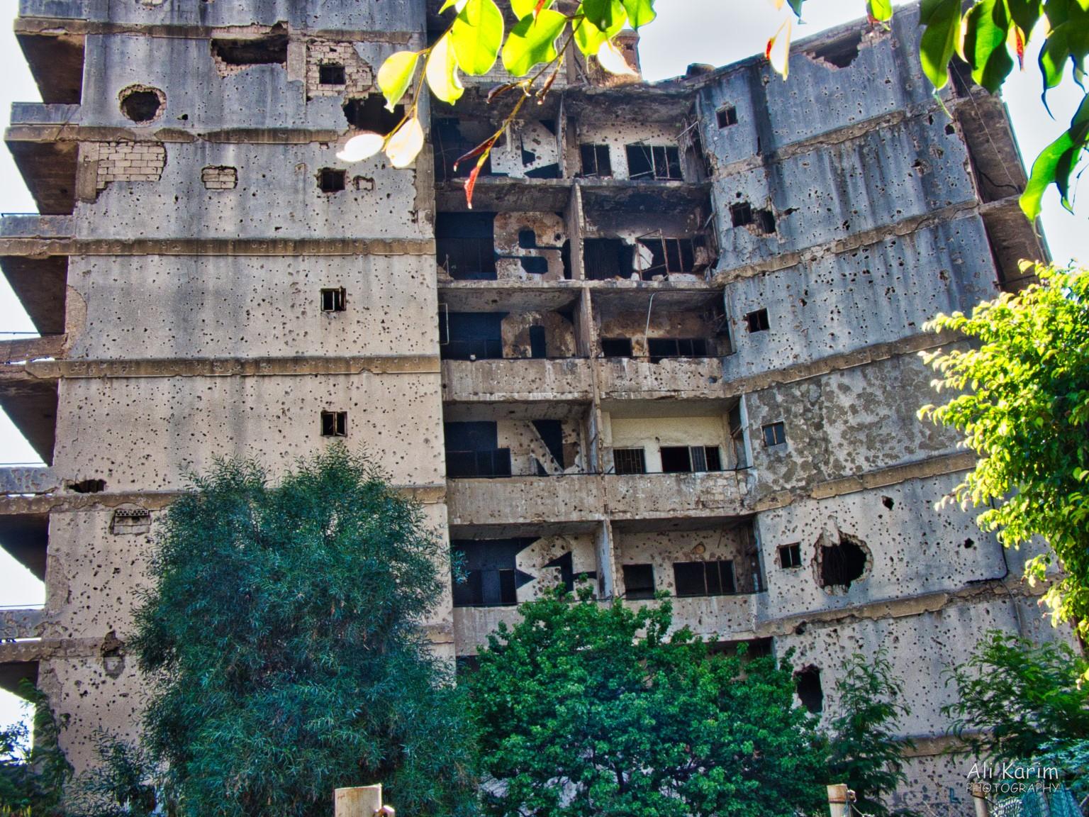 Building in much worse shape with bullet and mortar shell holes Building in much worse shape with bullet and mortar shell holes
