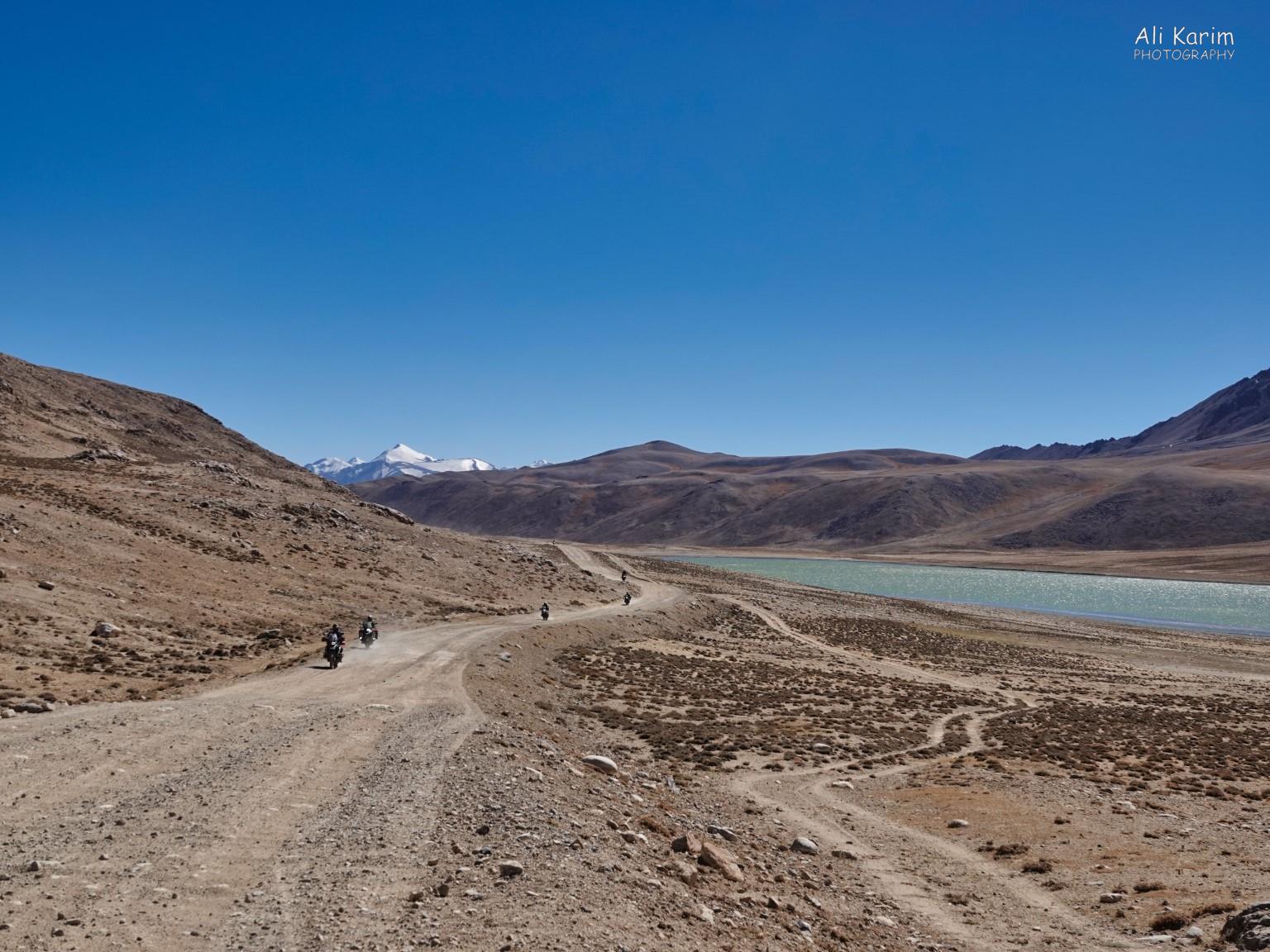 At Kargush Pass (Pereval Kargush, 4300m (14,100ft)); bikers heading north towards Alichur. We were heading south to the Wakhan corridor and the snow capped Pamir peaks in Afghanistan Langar, Tajikistan, At Kargush Pass (Pereval Kargush, 4300m (14,100ft)); bikers heading north towards Alichur. We were heading south to the Wakhan corridor and the snow capped Pamir peaks in Afghanistan