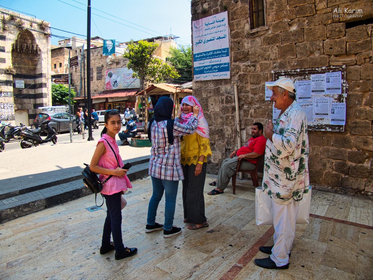 Getting covered properly with help from a complete stranger passing by, before visiting the Grand Mosque. Ali Khawaja in the Hawaiian shirt, is enjoying the scene Tripoli Lebanon Getting covered properly with help from a complete stranger passing by, before visiting the Grand Mosque. Ali Khawaja in the Hawaiian shirt, is enjoying the scene