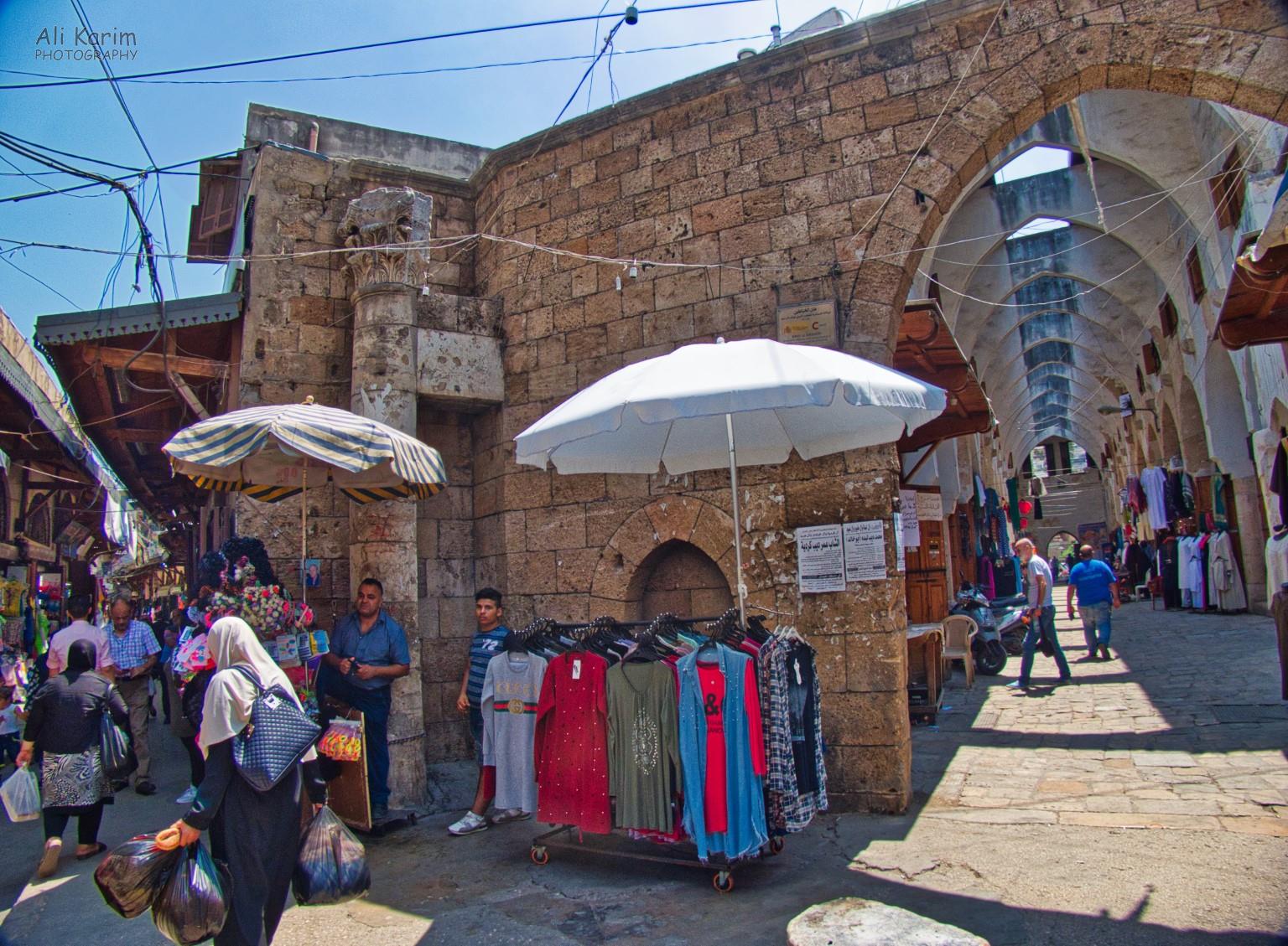 Clothes Hamam; note the shopkeeper center-left, leaning on the old Roman Column Tripoli Lebanon Clothes Hamam; note the shopkeeper center-left, leaning on the old Roman Column