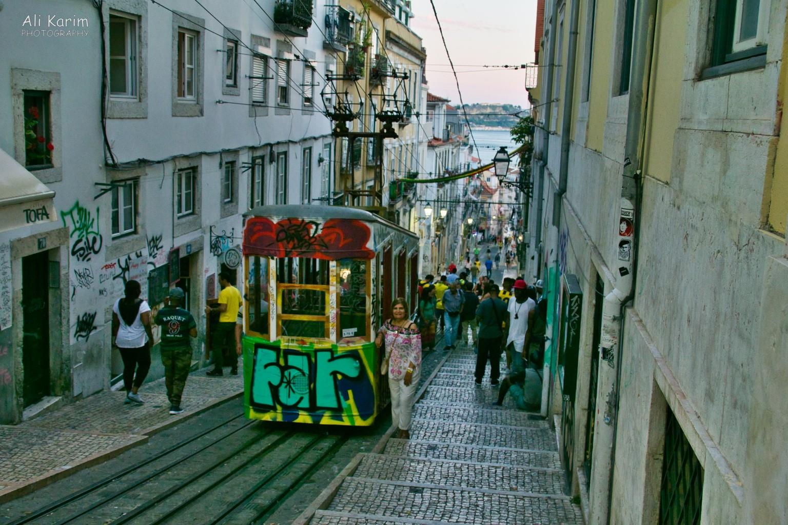 The Ascensor de Bica funicular, with lively action along its tracks in the evenings Lisbon Portugal: The Ascensor de Bica funicular, with lively action along its tracks in the evenings