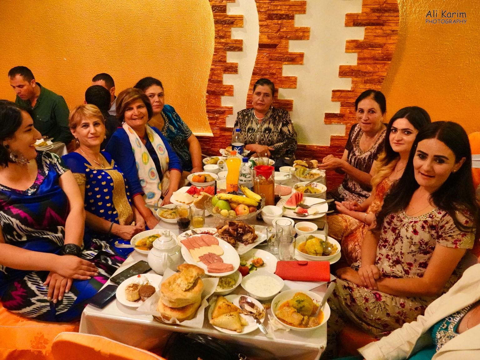 Dilshad with Gulguncha on her right, at their table. Notice how the table is overflowing with food Onto Khorog, Tajikistan, Dilshad with Gulguncha on her right, at their table. Notice how the table is overflowing with food