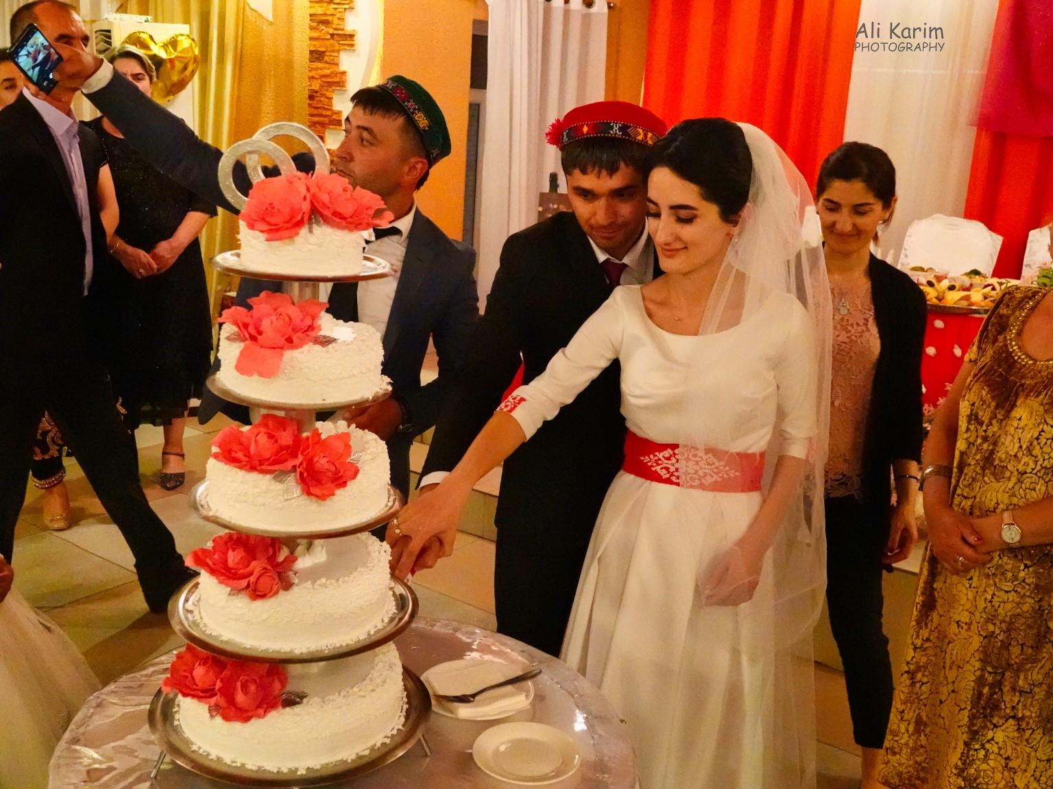 The wedding couple cut the cake Onto Khorog, Tajikistan, The wedding couple cut the cake