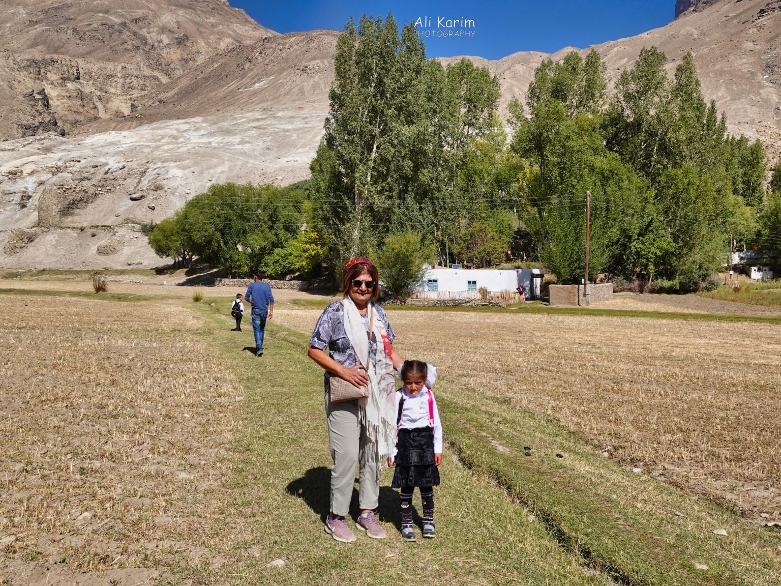 Langar, Bulunkul Tajikistan, Aziz leading us to the Budhist Stupka ruins, on the hills behind the fields