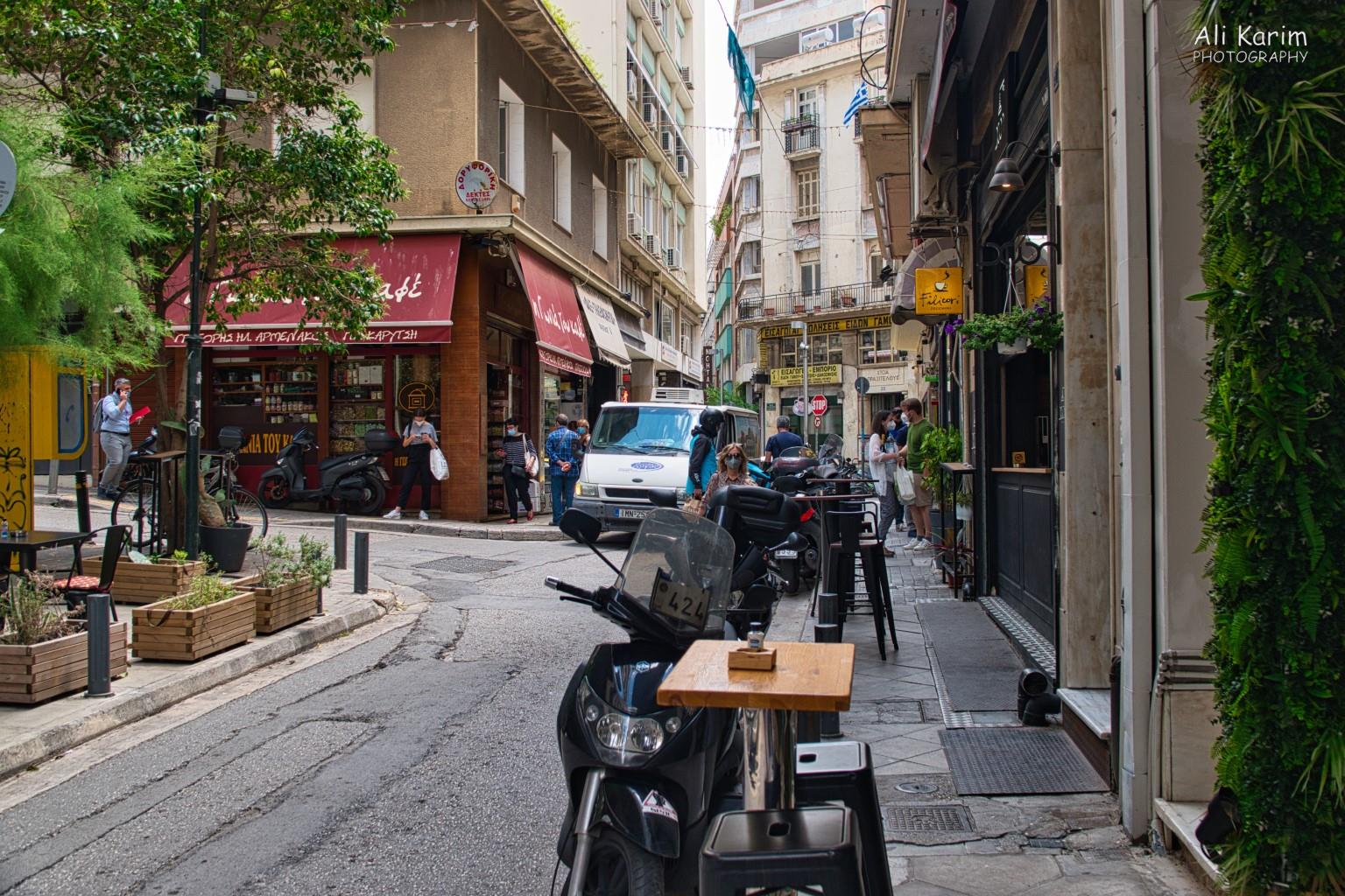 More Athens, Greece, May 2021, Small streets of the old city with narrow sidewalks where you can still have patio dining.