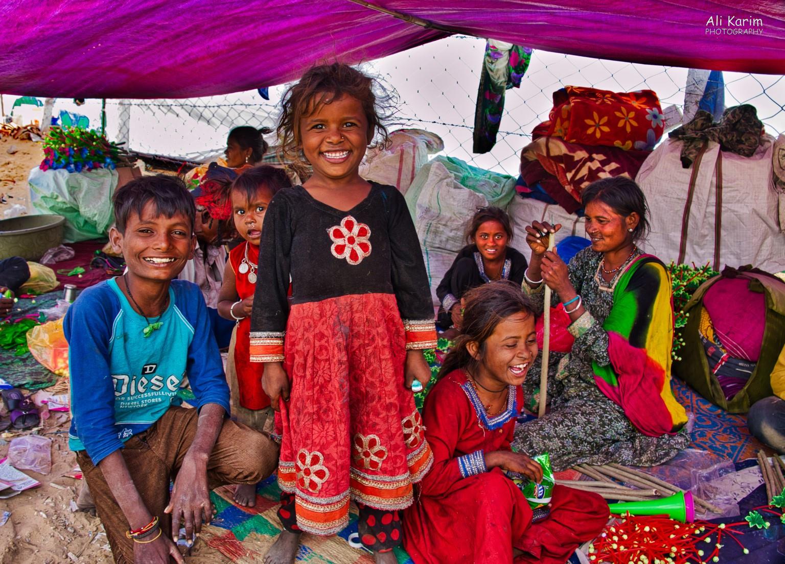 This family made plastic flower bouquets to adorn camels and horses with. The kids were having a great time Pushkar, Rajasthan This family made plastic flower bouquets to adorn camels and horses with. The kids were having a great time