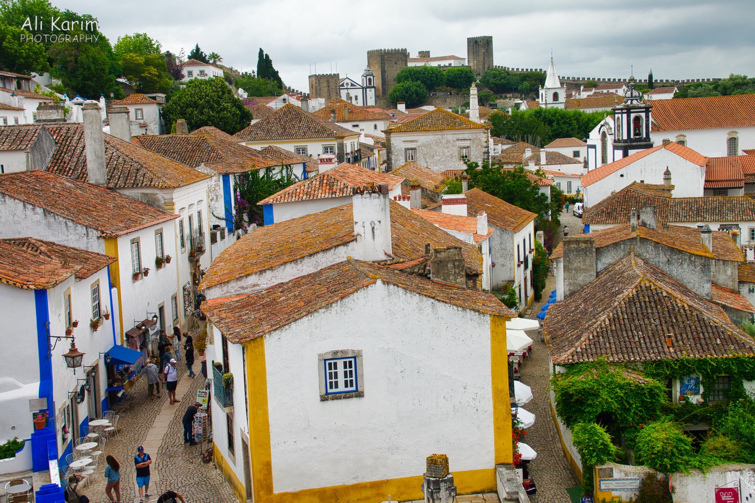 Obidos town and castle in the back, fortified wall going to the right and left of the castle West of Lisbon Obidos town and castle in the back, fortified wall going to the right and left of the castle
