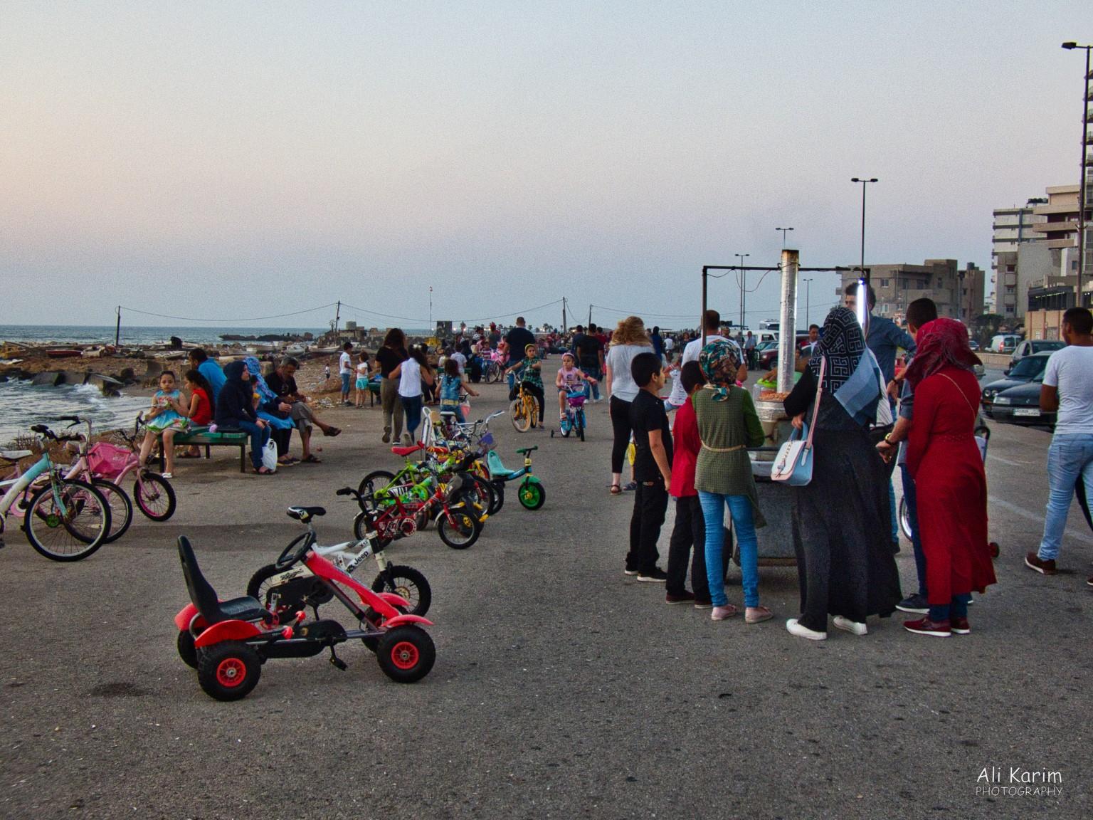 Busy corniche area with lots of families, street vendors, bicycles, scooters and people Beirut to Tripoli Busy corniche area with lots of families, street vendors, bicycles, scooters and people