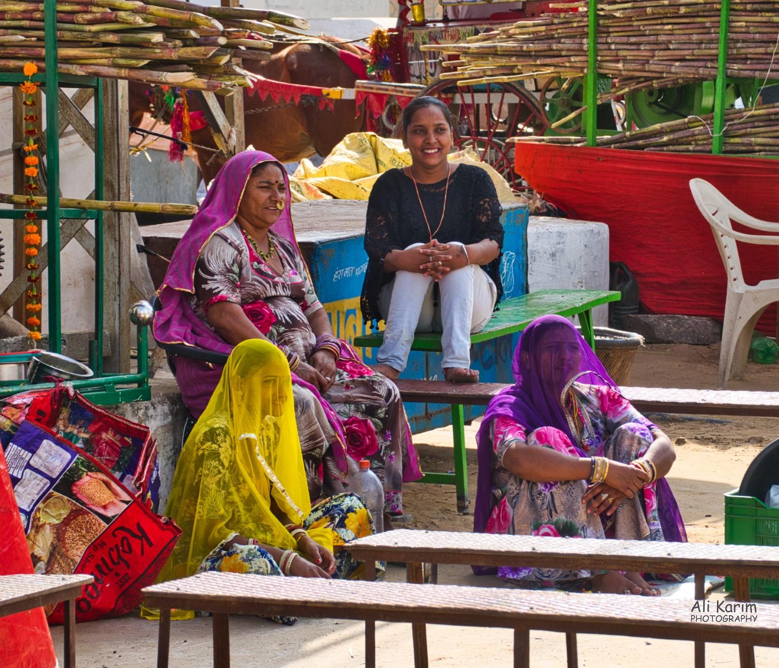 Local women people watching; note how many women cover their faces with their shawls to prevent the evil eye Pushkar, Rajasthan Local women people watching; note how many women cover their faces with their shawls to prevent the evil eye