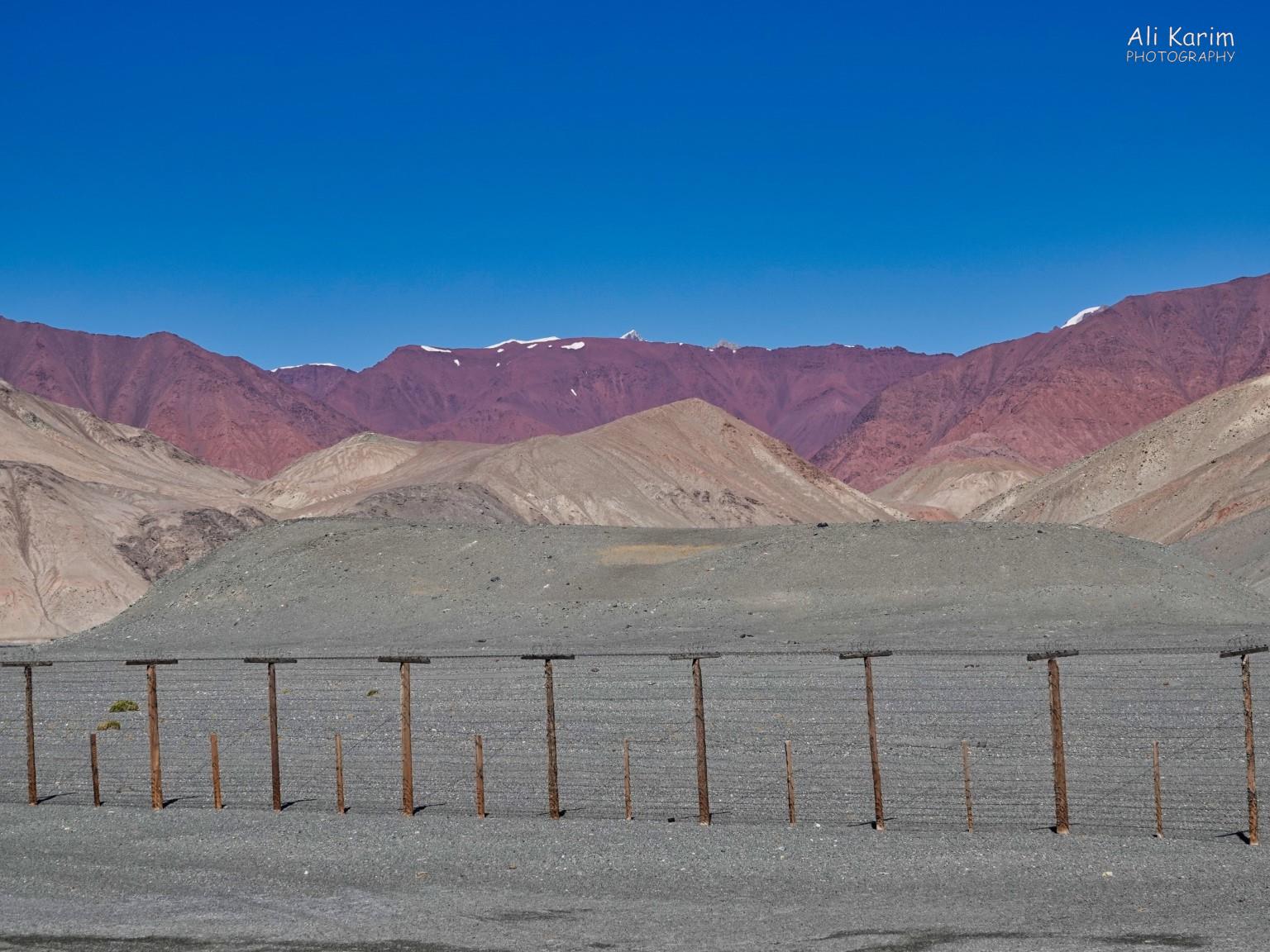 Border fence erected by the Soviets, to create a buffer zone with China, which is on the other side of these Pamir mountains Silk Road 18: Murghab, Tajikistan Border fence erected by the Soviets, to create a buffer zone with China, which is on the other side of these Pamir mountains