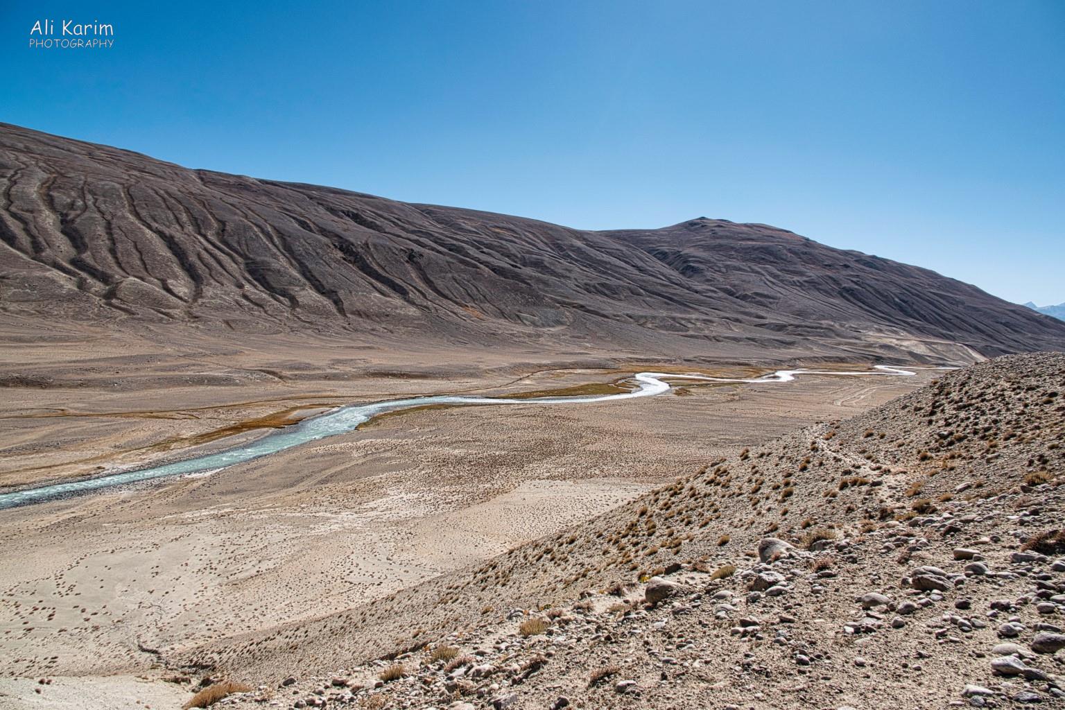 Our road meets the Panj river at Khargush. Afghanistan is on the opposite side. Langar, Tajikistan, Our road meets the Panj river at Khargush. Afghanistan is on the opposite side.