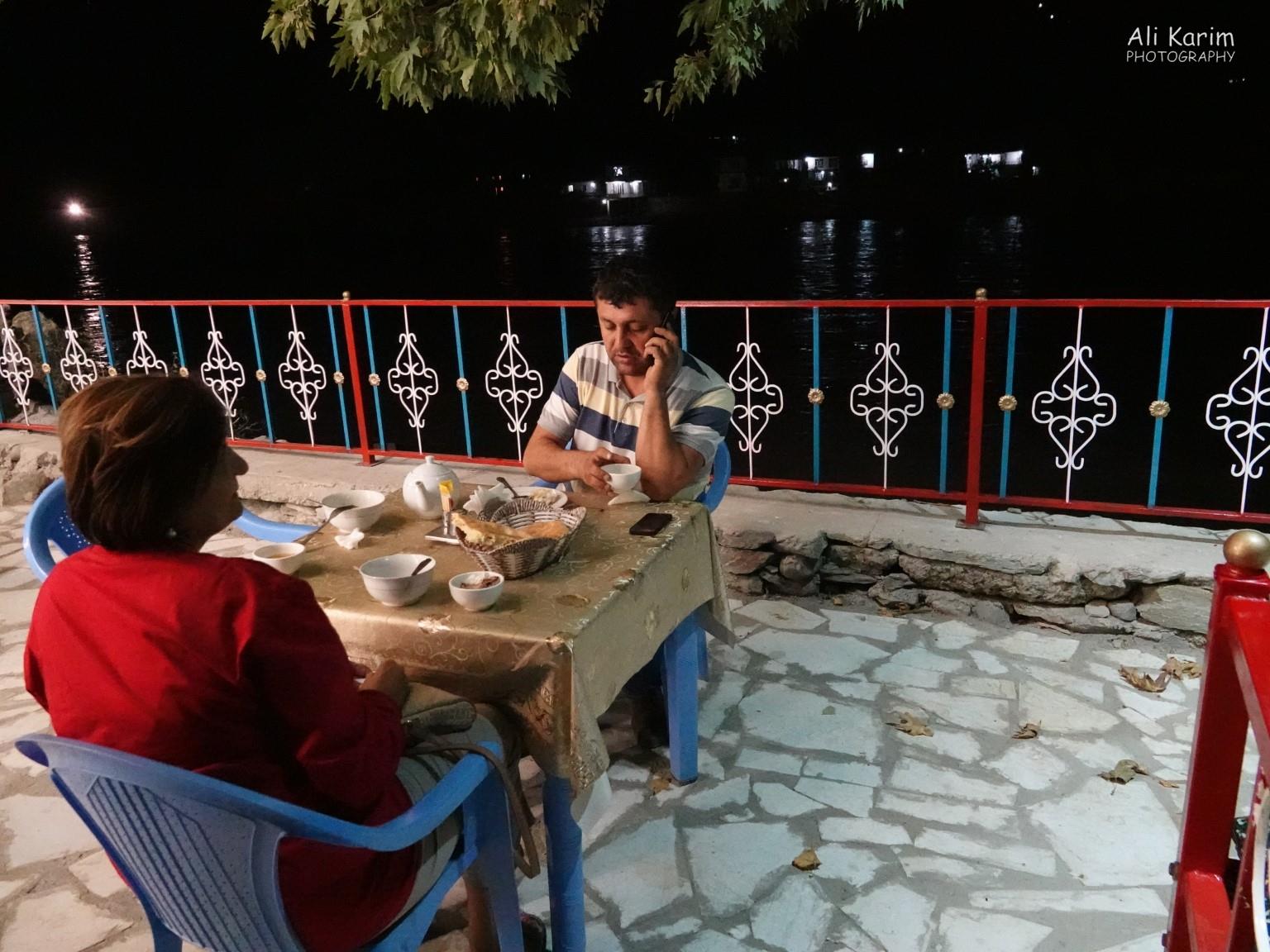 Dinner with our driver at Sharq-Davroz along the Panj river, with Afghanistan town lights visible in the background across the river Dushanbe, Tajikistan Dinner with our driver at Sharq-Davroz along the Panj river, with Afghanistan town lights visible in the background across the river