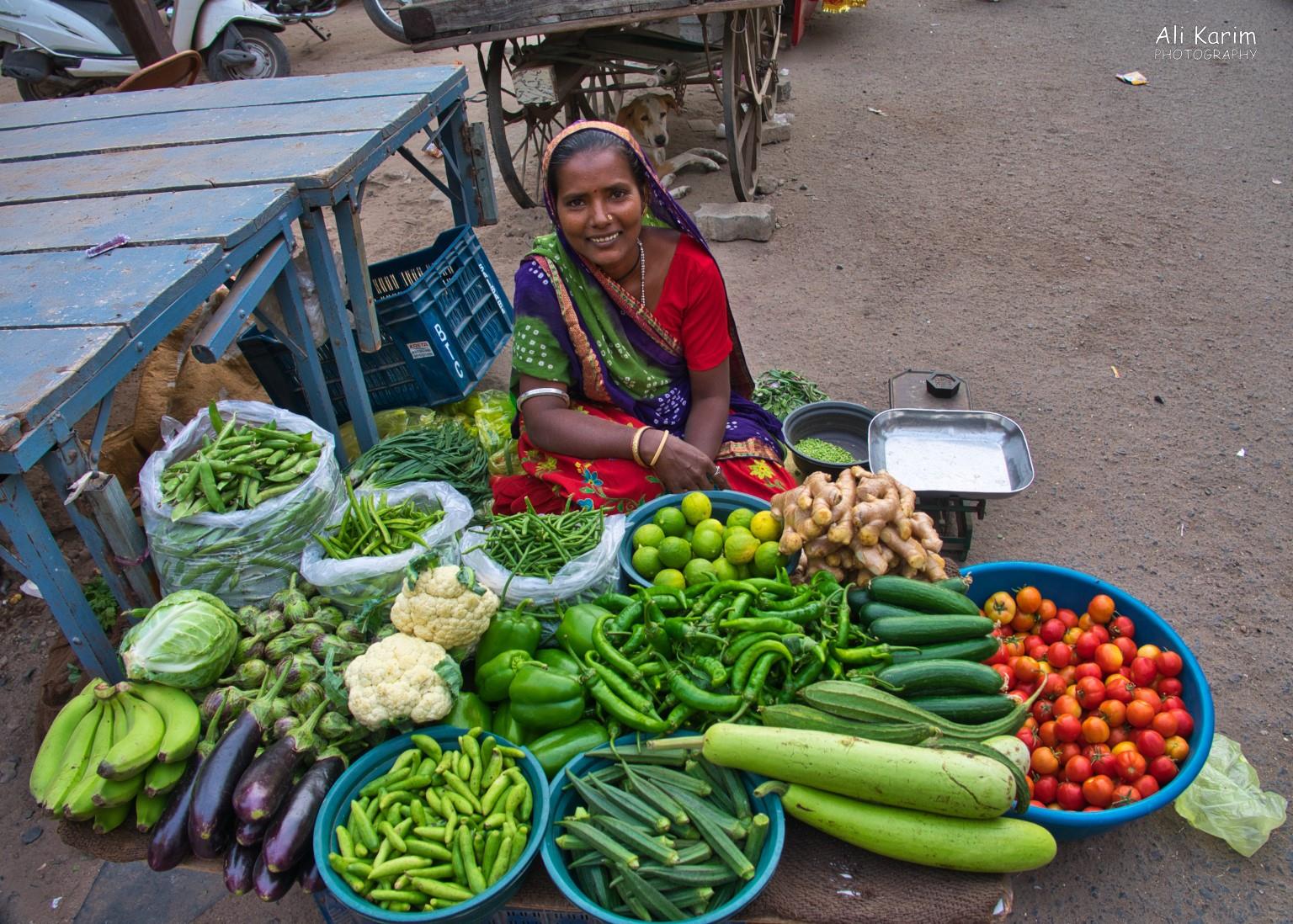 Happy vegetable seller outside the vegetable market in the heart of the old city More Bhuj Happy vegetable seller outside the vegetable market in the heart of the old city